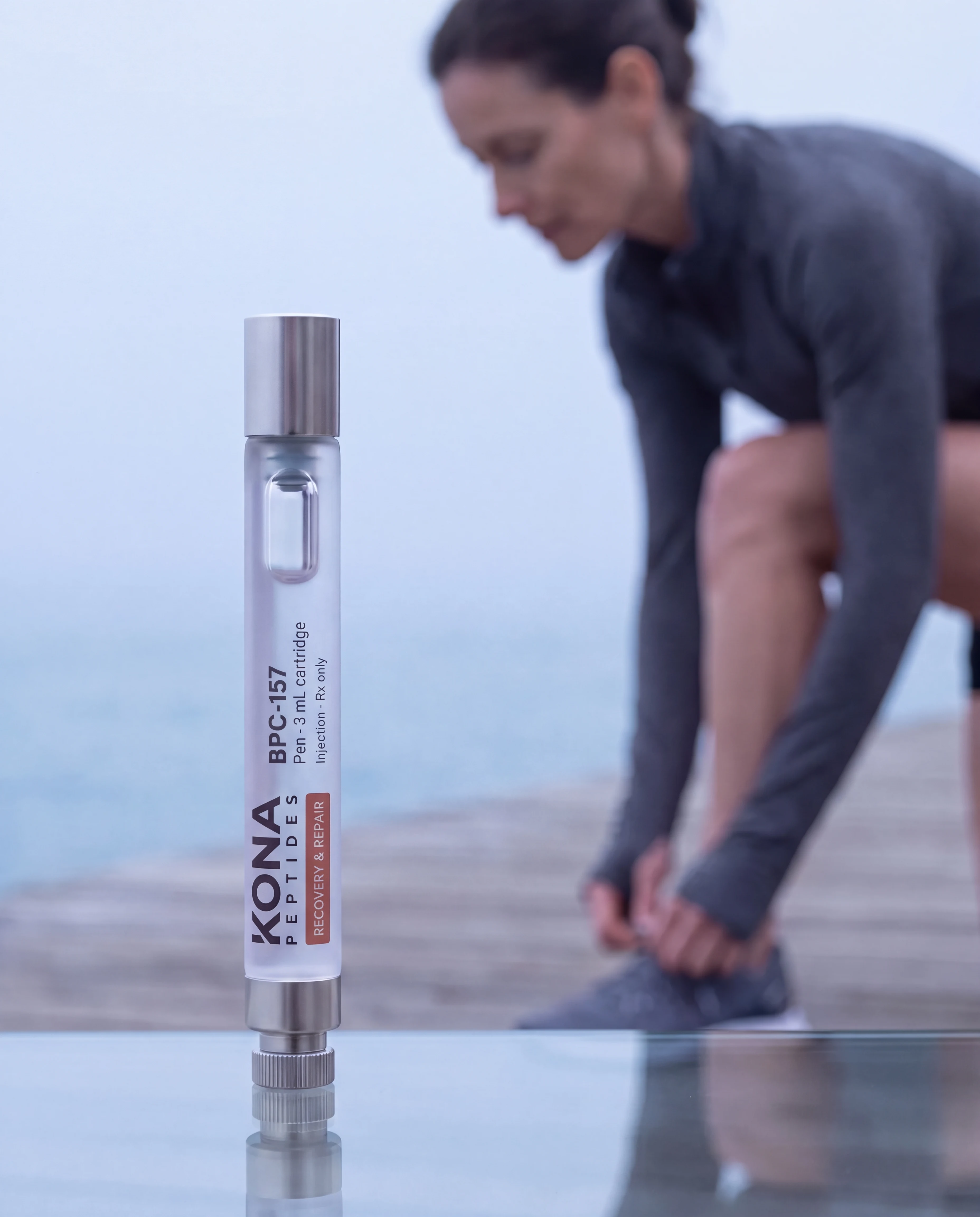 A BPC-157 pen in front of a woman tying her running shoe